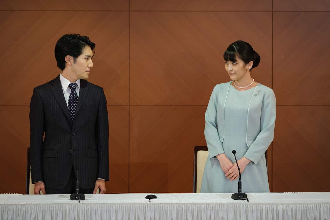 Princess Mako (R), the elder daughter of Prince Akishino and Princess Kiko, and her husband Kei Komuro (L), a university friend of Princess Mako, poses during a press conference to announce their marriage registration at Grand Arc Ho