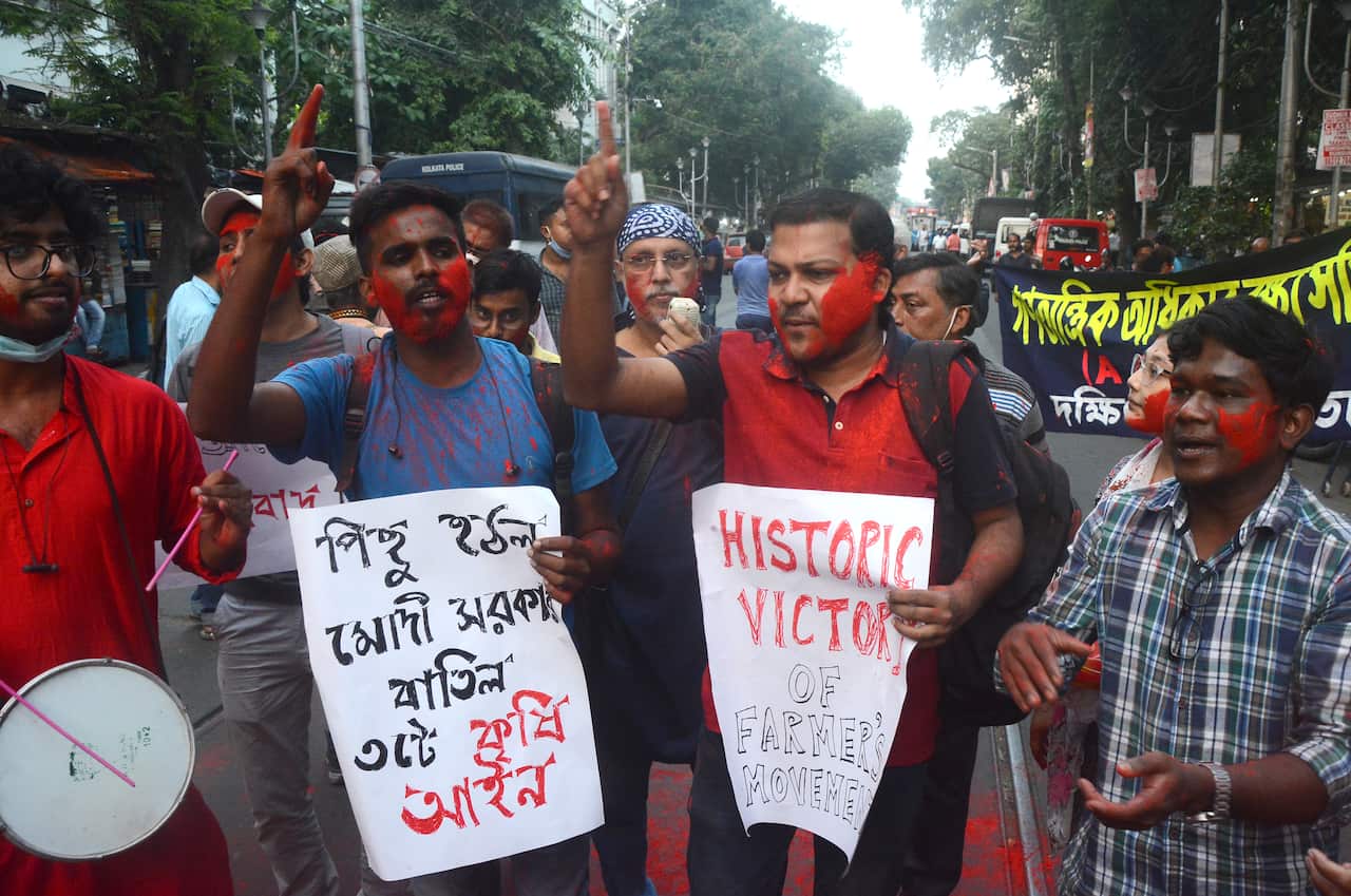 People celebrate in Kolkata, India on Nov. 19, 2021 after Indian PM Narendra Modi announced the repeal of three controversial farm laws after a year of protests