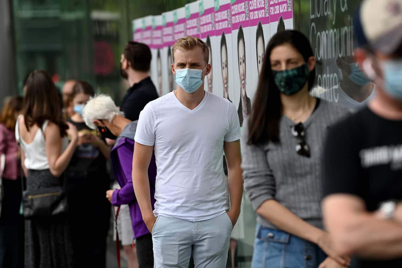 Members of the public line up to vote during NSW local council elections day at Surry Hills Library in Sydney.