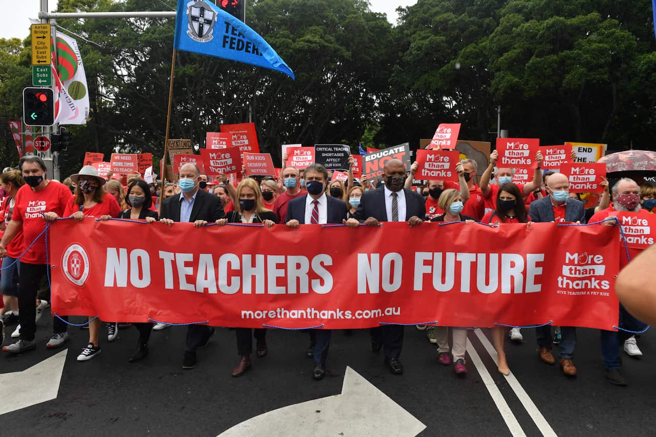 Teachers march on Parliament House during a strike by NSW public school teachers and principals in Sydney, Tuesday, December 7, 2021. NSW teachers are stopping work over staff shortages and uncompetitive salaries.