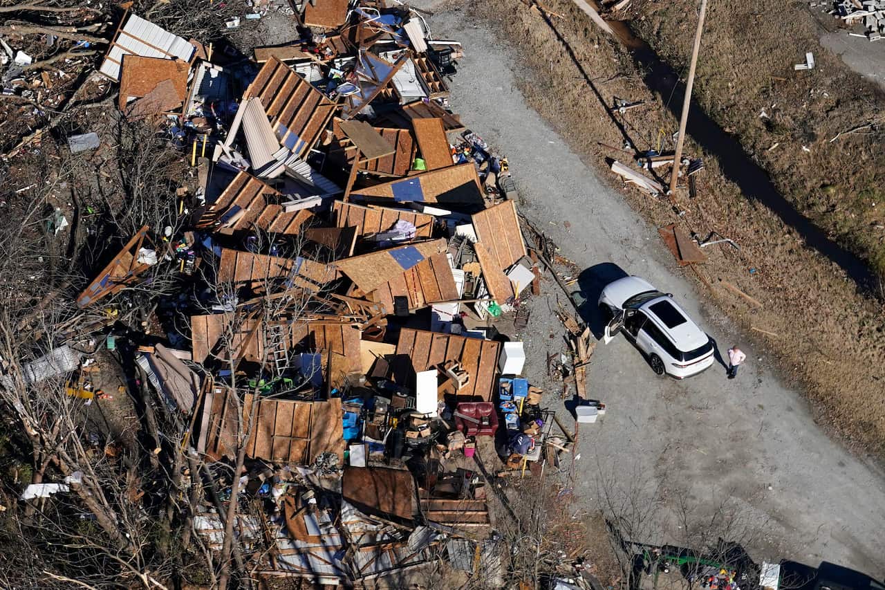 In this aerial photo, a person stands next to a destroyed home in the aftermath of tornadoes that tore through the region, in Dresden, Tenn., Sunday, Dec. 12, 2021.