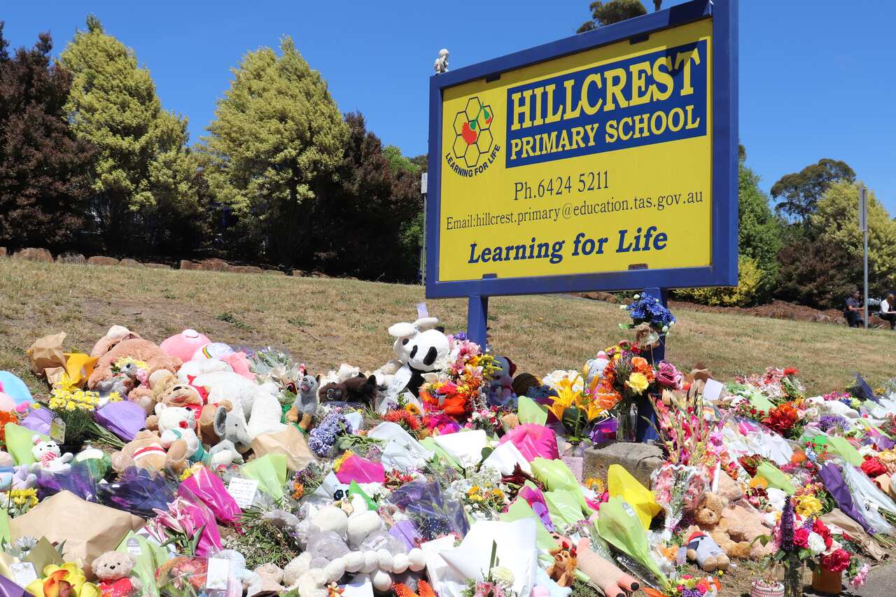 Flowers and tributes are seen outside Hillcrest Primary School in Devonport, Tasmania, Friday, December 17, 2021. The death toll from a freak jumping castle accident at a primary school in Tasmania's northwest remains at five, and three children are in ho