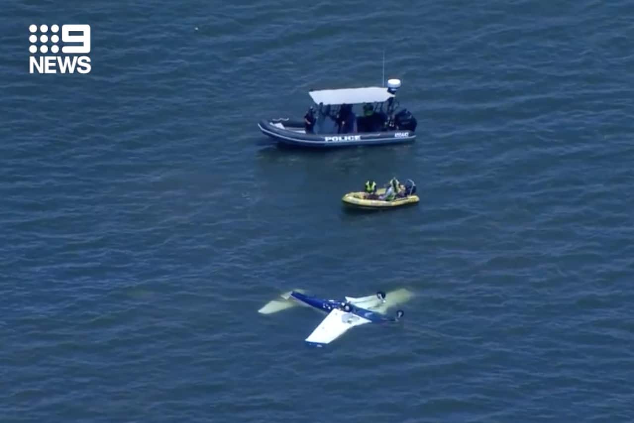 A screenshot obtained from a Nine News broadcast on Sunday, December 19, 2021, shows a light plane in water off the coast of Redcliffe, north-east of the Brisbane. Four people have died following a plane crash off the coast of Redcliffe shortly after 9am 