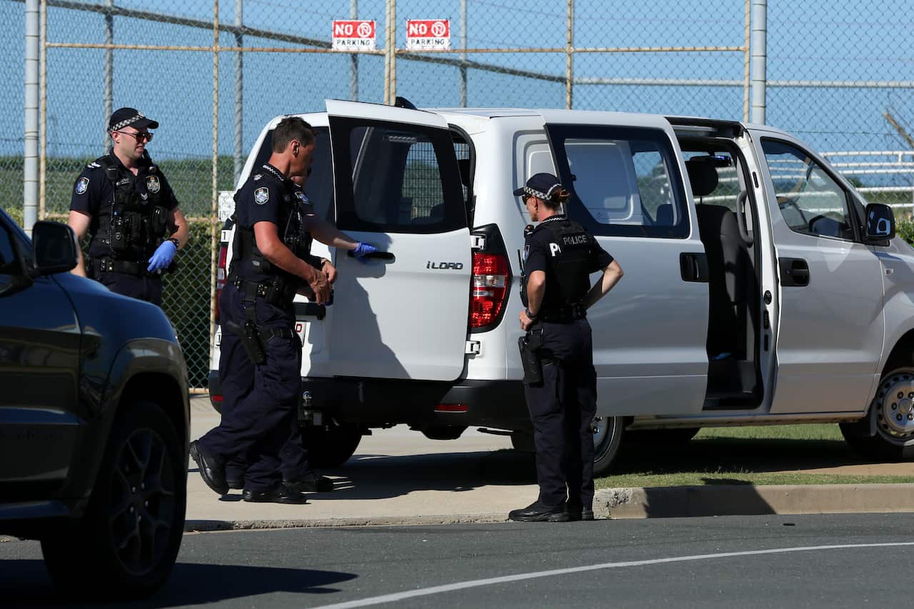 Queensland Police and Forensic teams are seen at the Scarborough Marina after a plane crashed into nearby waters, north of  Brisbane, Sunday, December 19, 2021. Queensland Police have confirmed two adults and two children have been killed in a light plane