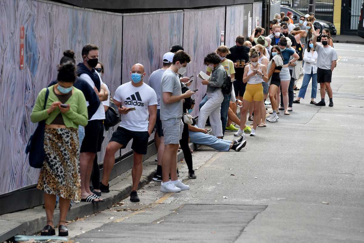 Members of the public queue for Covid19 PCR tests at a clinic in Redfern in Sydney, Friday, December 24, 2021. Indoor mask wearing, compulsory QR code check-ins and other restrictions lifted in NSW on December 15 will be reintroduced amid a record spike i