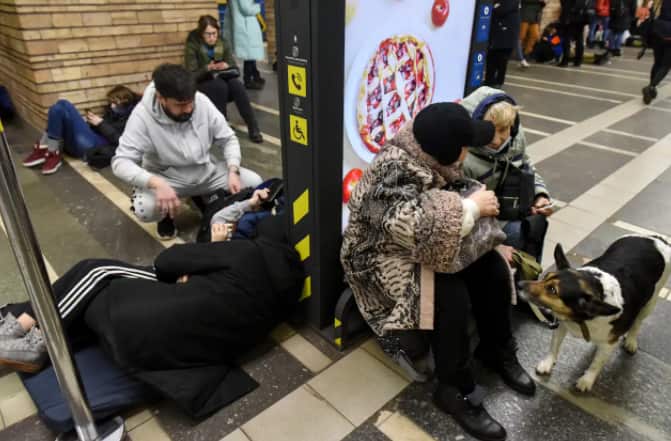 Ukrainians take shelter in a metro station after air raid sirens alarm in Kyiv. 
