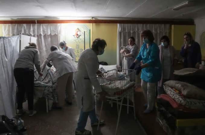 Medical workers tend to women who gave birth in a basement of a maternity hospital converted into a medical ward and used as a bomb shelter in Mariupol, Ukraine, on Tuesday 1 March 2022.