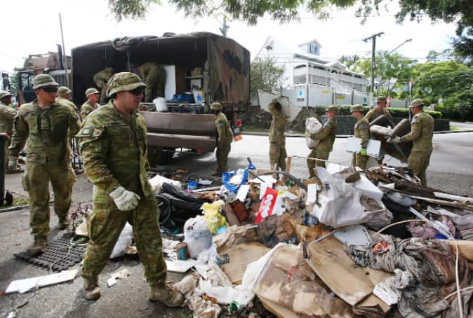 Members of the ADF help clean up flooded streets in Milton, Brisbane, Monday, on 7 March, 2022. 