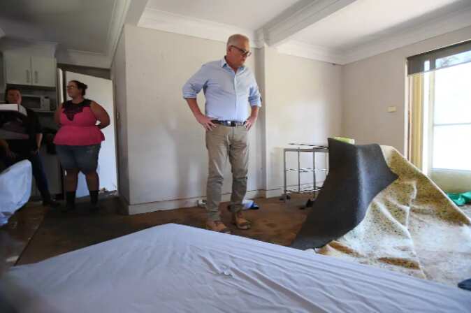 Prime Minister Scott Morrison and his wife Jenny visit the flood affected property of Darren Vaughan and Chloe Konispoliatis on Old Hawkesbury Road at McGraths Hill in Sydney, Saturday, March 12, 2022. 