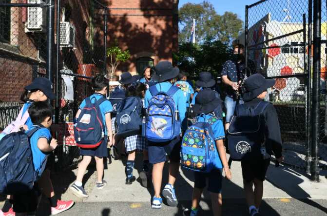 Students arrive at Carlton Gardens Primary School in Melbourne. 