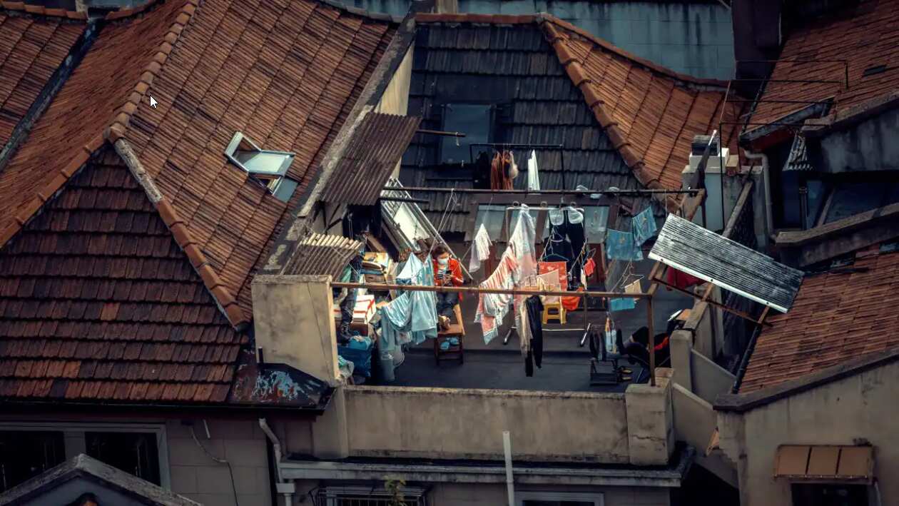 A woman in quarantine sits on her roof balcony, amid Covid-19 full lockdown of the city in Shanghai