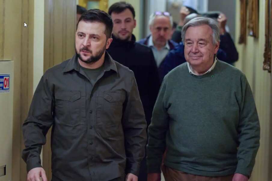 Ukrainian President Volodymyr Zelenskyy, left, and UN Secretary-General Antonio Guterres walk in the hall during their meeting in Kyiv
