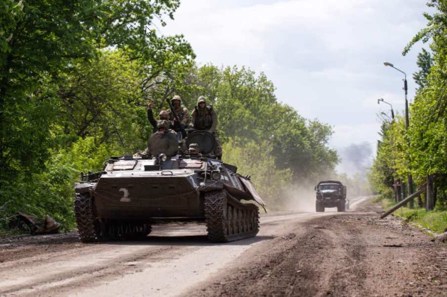 Russian Army servicemen ride an infantry combat vehicle in the town of Popasnaya which came under control of the Lugansk People's Republic on May 8.