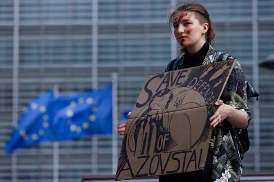 A woman takes part in a rally to call EU countries to "stop buying Russian gas and save defenders of Azovstal"