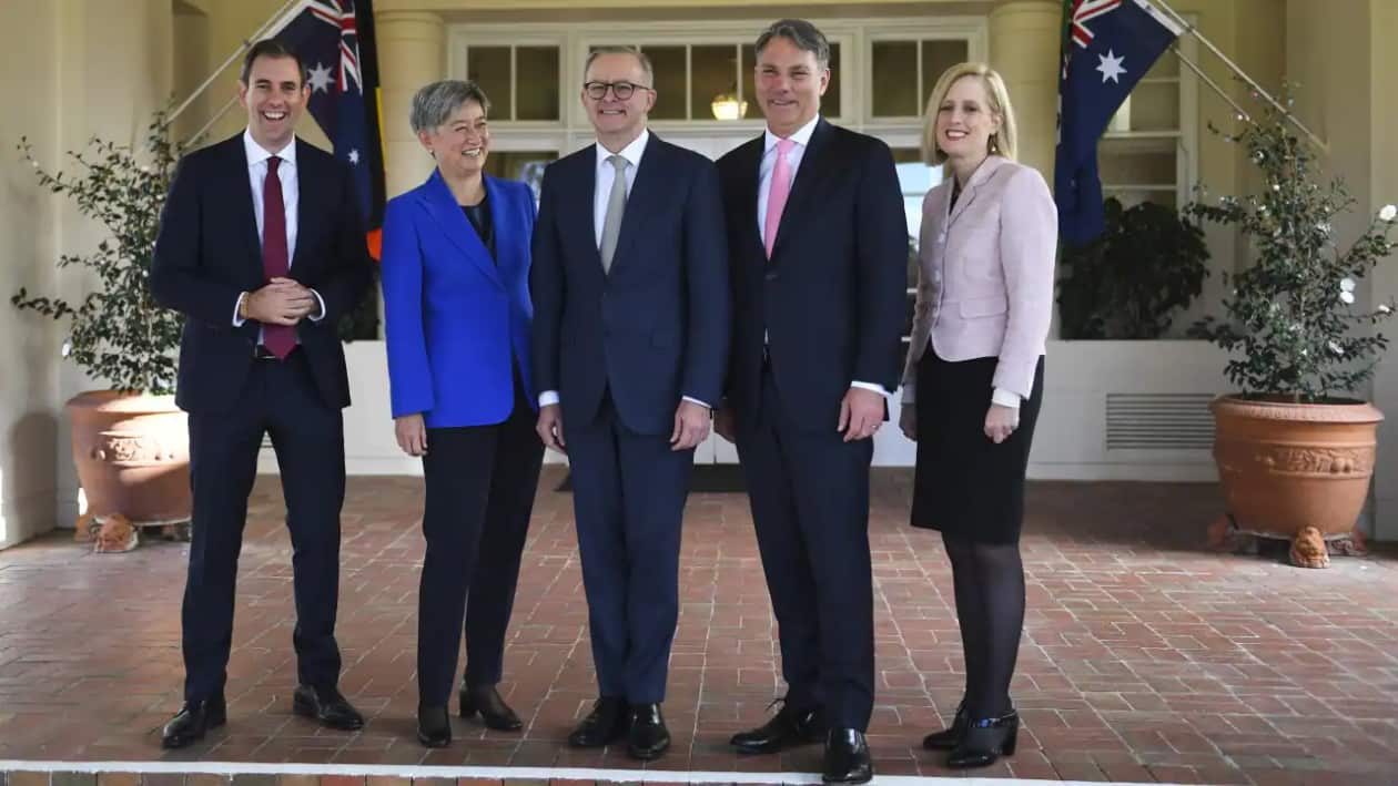 Prime Minister Anthony Albanese(centre) poses for photographs with interim ministers after a swearing-in ceremony at Government House in Canberra on Monday
