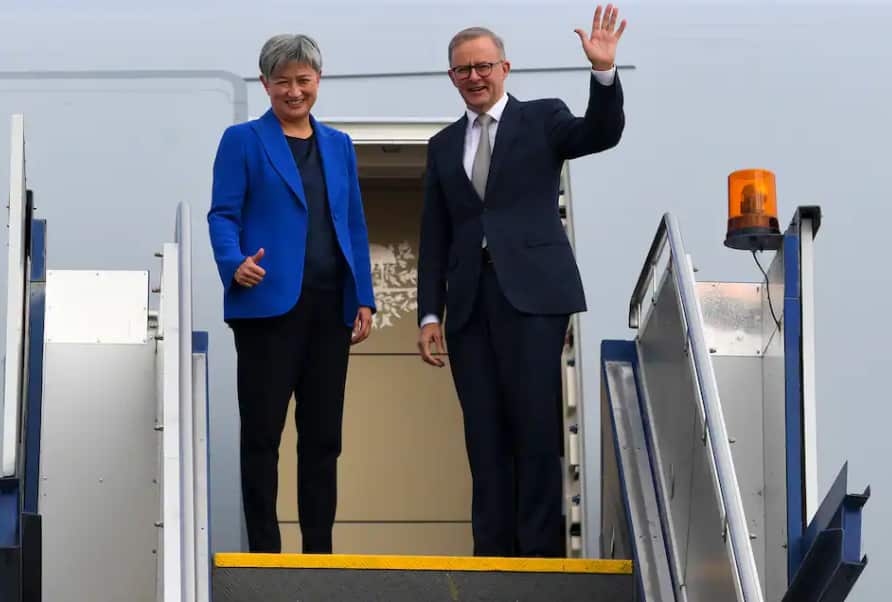 Prime Minister Anthony Albanese and Australian Foreign Minister Penny Wong wave as they board the plane to Japan to attend the QUAD leaders meeting in Tokyo, Canberra.