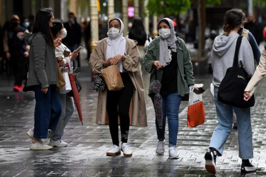 Young people wear face masks in Pitt St Mall, following 108 days of lockdown in Sydney, 11 October 2021