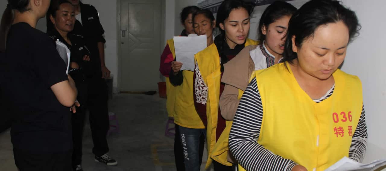 An image from inside the rarely seen confines of a detention centre, which appears to show Uyghurs being “re-educated”
