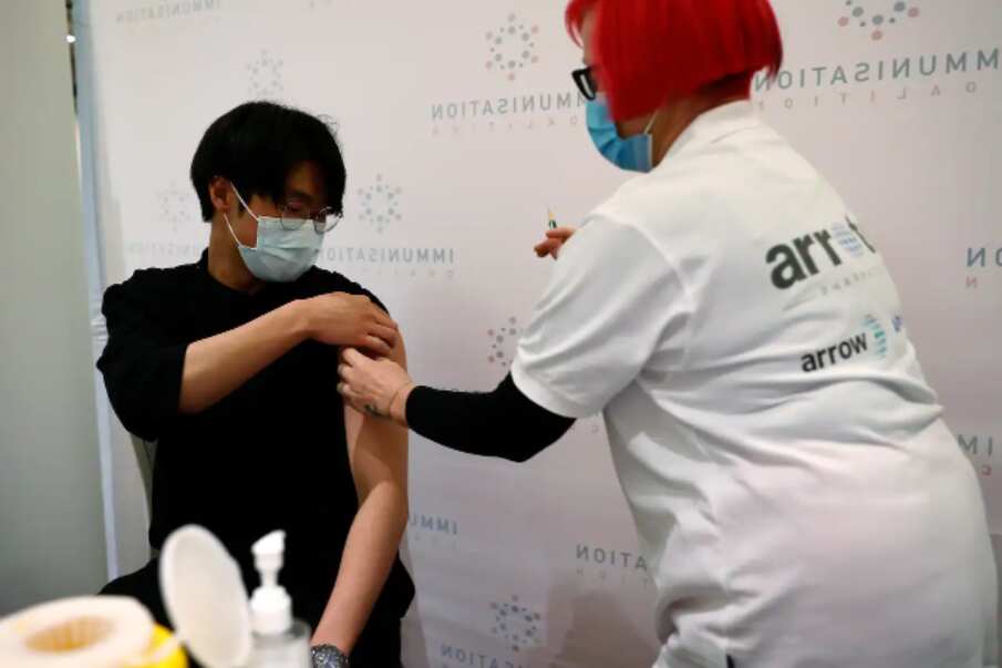 A man receives a free flu vaccination at Melbourne Town Hall.