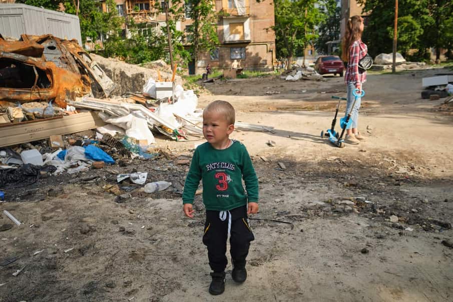 A boy walks through the wreckage of a destroyed building. As the city of Kiev tries to return to normality, the streets are a reminder that the war is still raging.