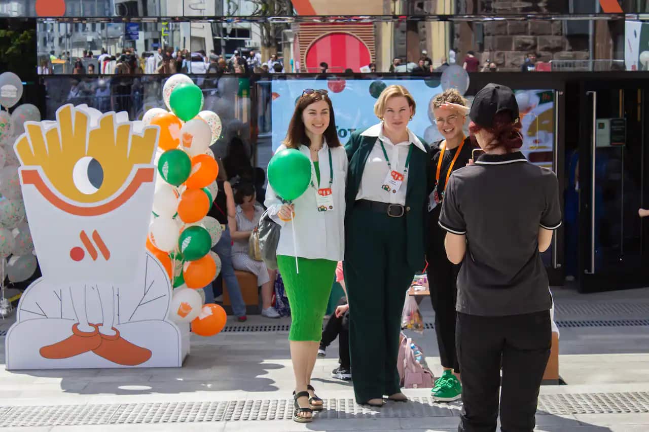 First customers pose for a photograph after eating from the new fast-food restaurant that came as a substitute for McDonald's on the Pushkinskaya Square in Moscow.