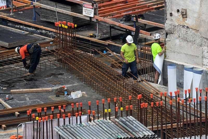 Workers are seen on a construction site in Sydney, T
