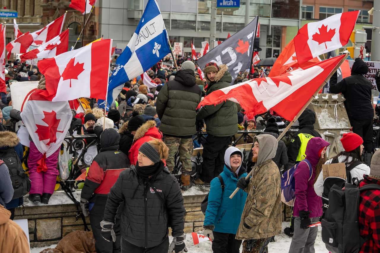 Protesters against COVID-19 restrictions gather on Parliament Hill in Ottawa on 12 Feb 2022.