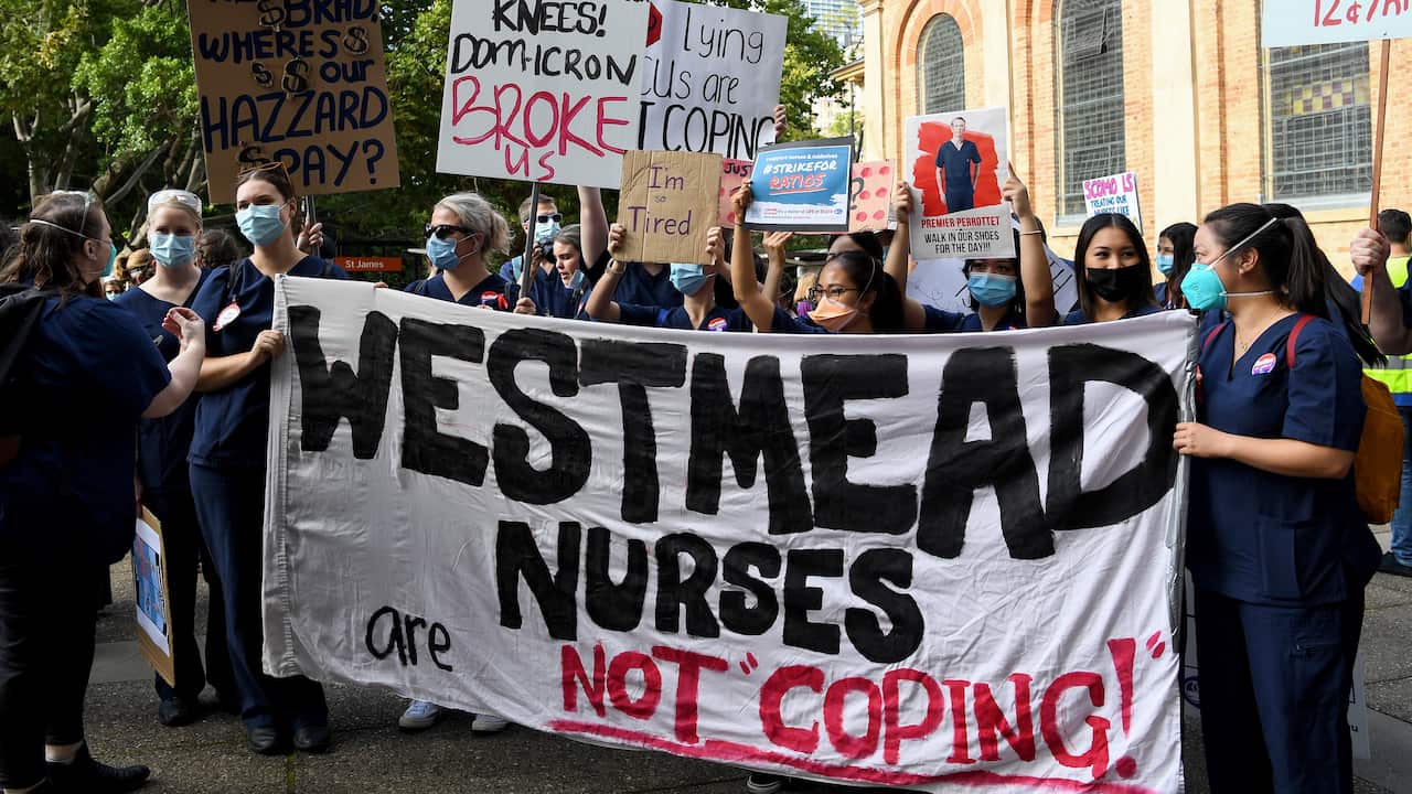 Nurses hold placards during a nurses’ strike in Queen’s Square, Sydney.