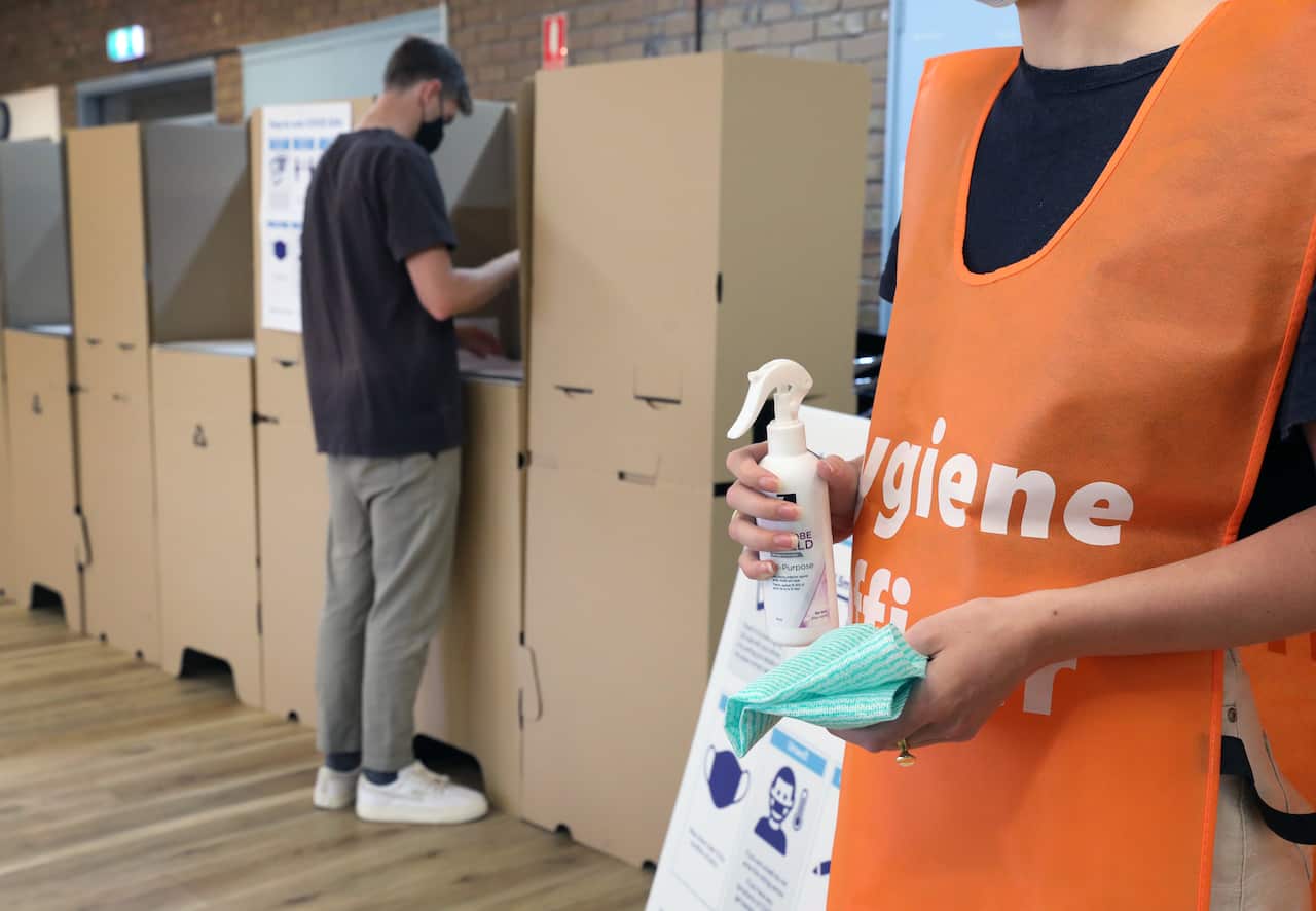 A scene demonstrating the role of hygiene officers at polling locations in South Australia.