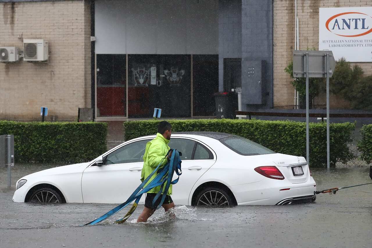  car is towed from a flooded road in Oxley, Saturday, February 26, 2022. 