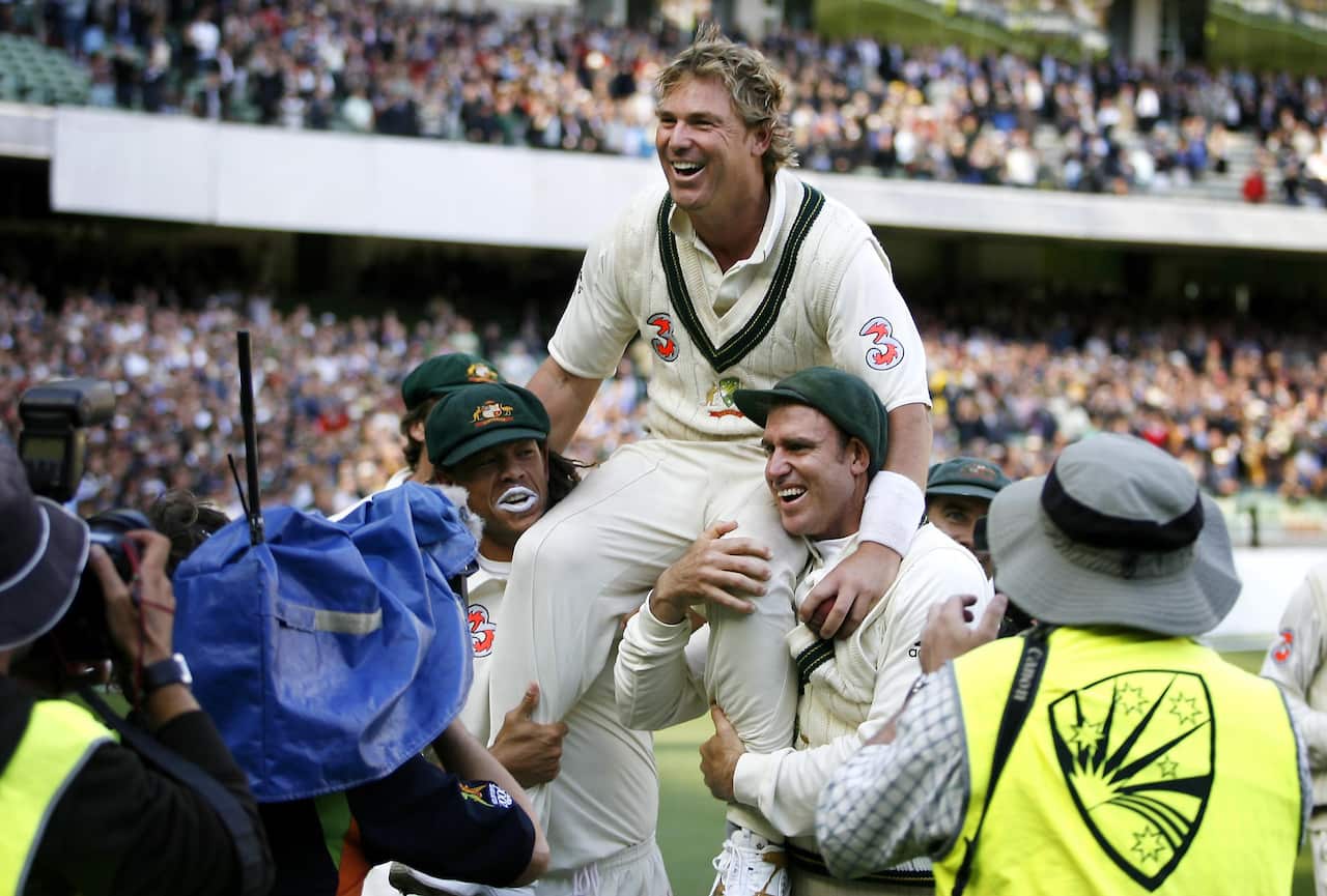 Shane Warne carried from the field by team-mates after defeating England in a Test match in 2006.