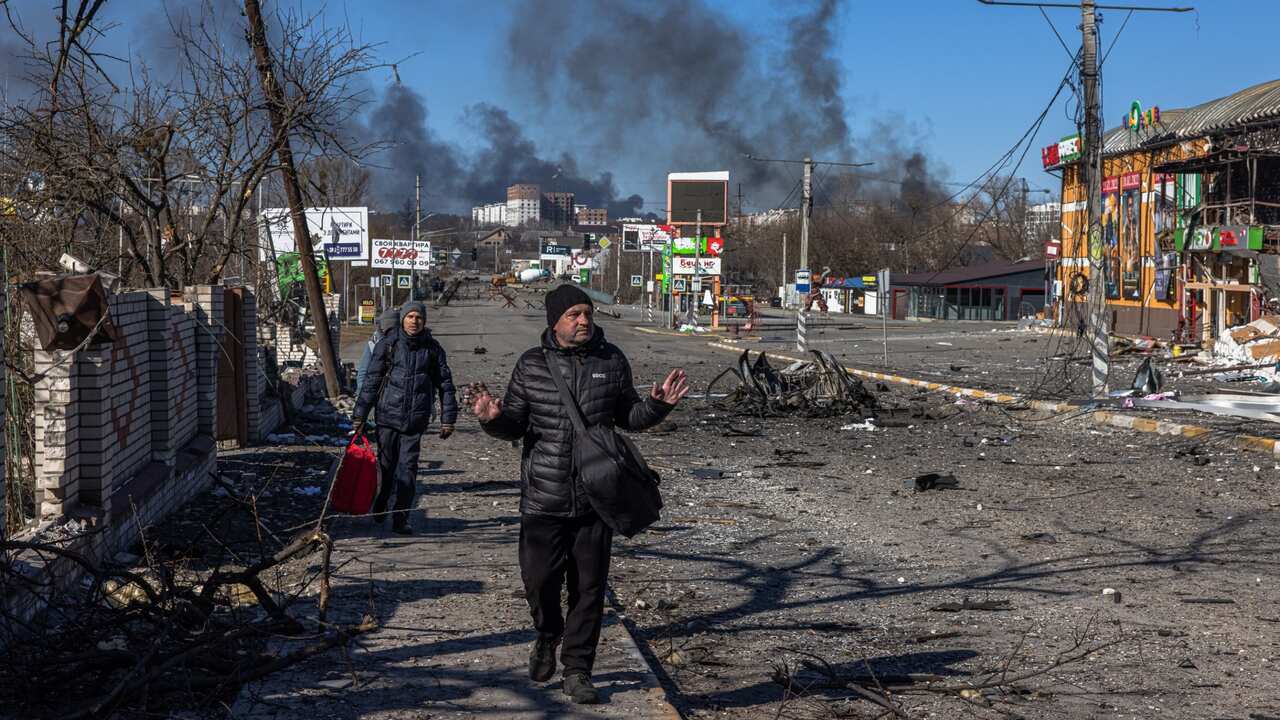 Residents coming from Bucha town, which is currently controlled by the Russian military, walk with luggage towards the Ukrainian checkpoint, at the frontline in Irpin town, Kyiv (Kiev) region, Ukraine, 10 March 2022.