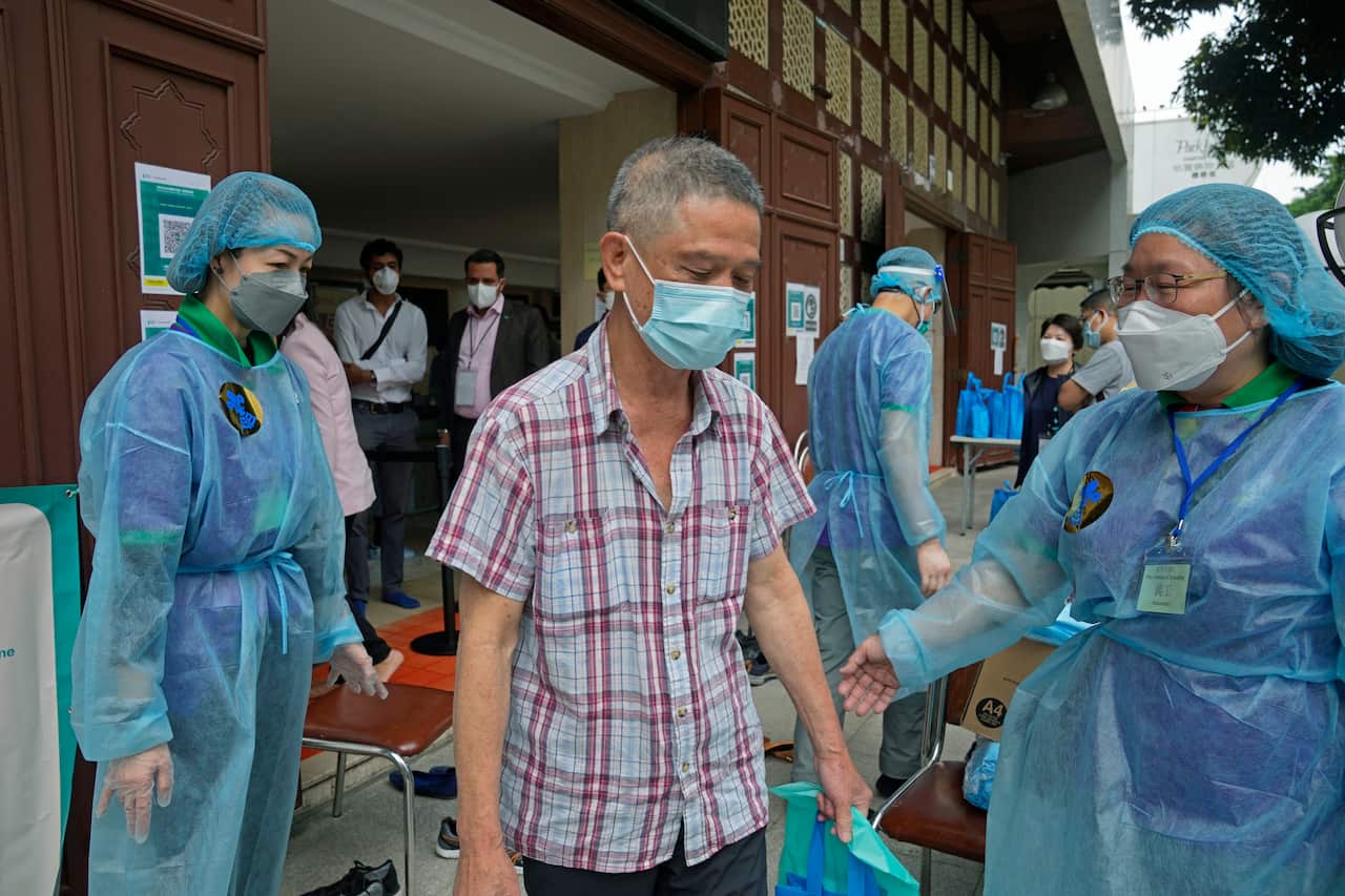 A man leaves after receing a dose of Pfizer-BioNTech COVID-19 coronavirus vaccine at a community vaccination center at the Kowloon Mosque And Islamic Centre, in Hong Kong, Saturday, March 19, 2022. Hong Kongs cumulative coronavirus infections have exceede