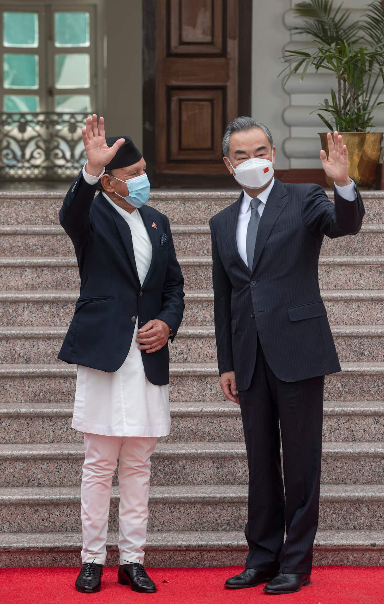 epa09850838 Nepal's Foreign Minister Narayan Khadka (L) and Chinese Foreign Minister Wang Yi (R) wave during their meeting at Singhadurbar in Kathmandu, Nepal, 26 March 2022. Wang Yi is in Nepal on a three-days official visit.  EPA/NARENDRA SHRESTHA