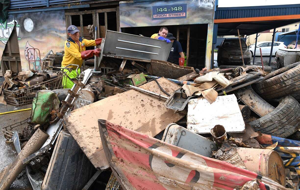 Volunteers from the NSW Rural Fire Service are seen cleaning up a flood damaged business which was inundated by flood waters in the February 28th floods in Lismore, NSW