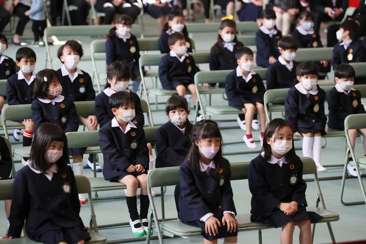 The entrance ceremony is held at an elementary school in Osaka City, Osaka Prefecture on April 7, 2022. New students wear face masks amid a pandemic of the new coronavirus COVID-19. ( The Yomiuri Shimbun via AP Images )