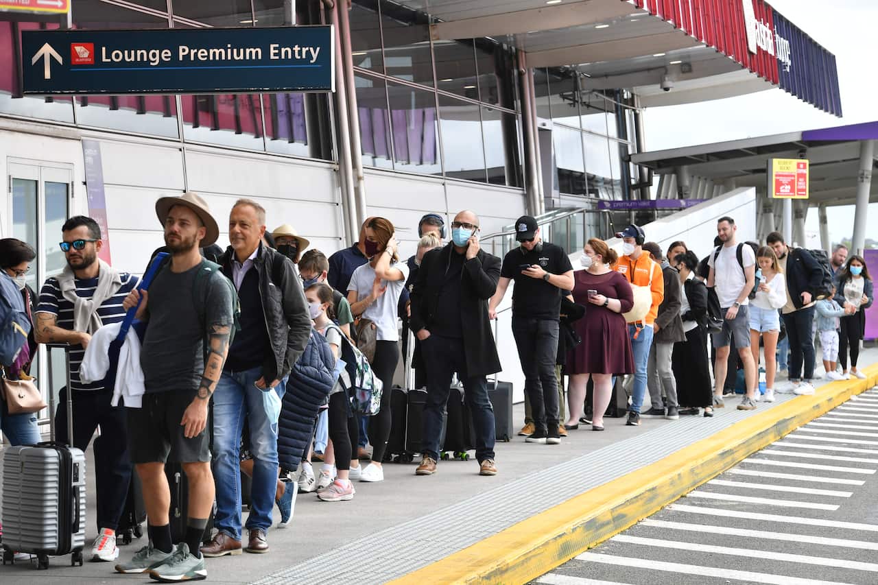 Huge queues are seen at the Virgin and Jetstar domestic departure terminal at Sydney Domestic Airport in Sydney, Friday, April 8, 2022. Domestic airline travels are queued outside the airport, forced to wait hours to get through check in and security. (AA