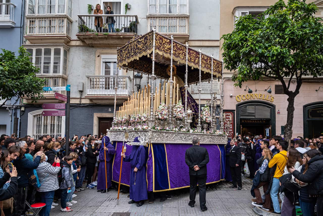 Penitents carrying the image of Jesus Christ during a procession as they celebrate Holy Tuesday in Spain