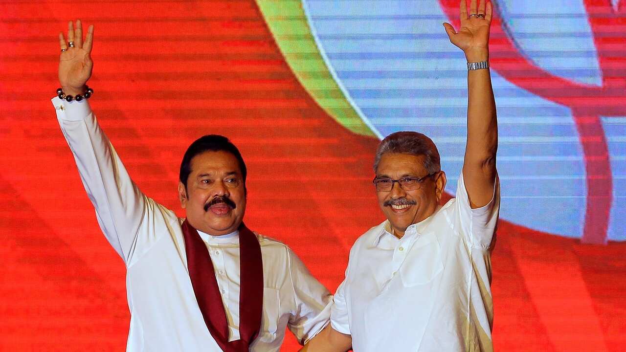 Mahinda Rajapaksa, left, and his brother Gotabaya Rajapaksa wave to supporters during a party convention held to announce the presidential candidacy in Colombo, Sri Lanka, Aug. 11, 2019. 