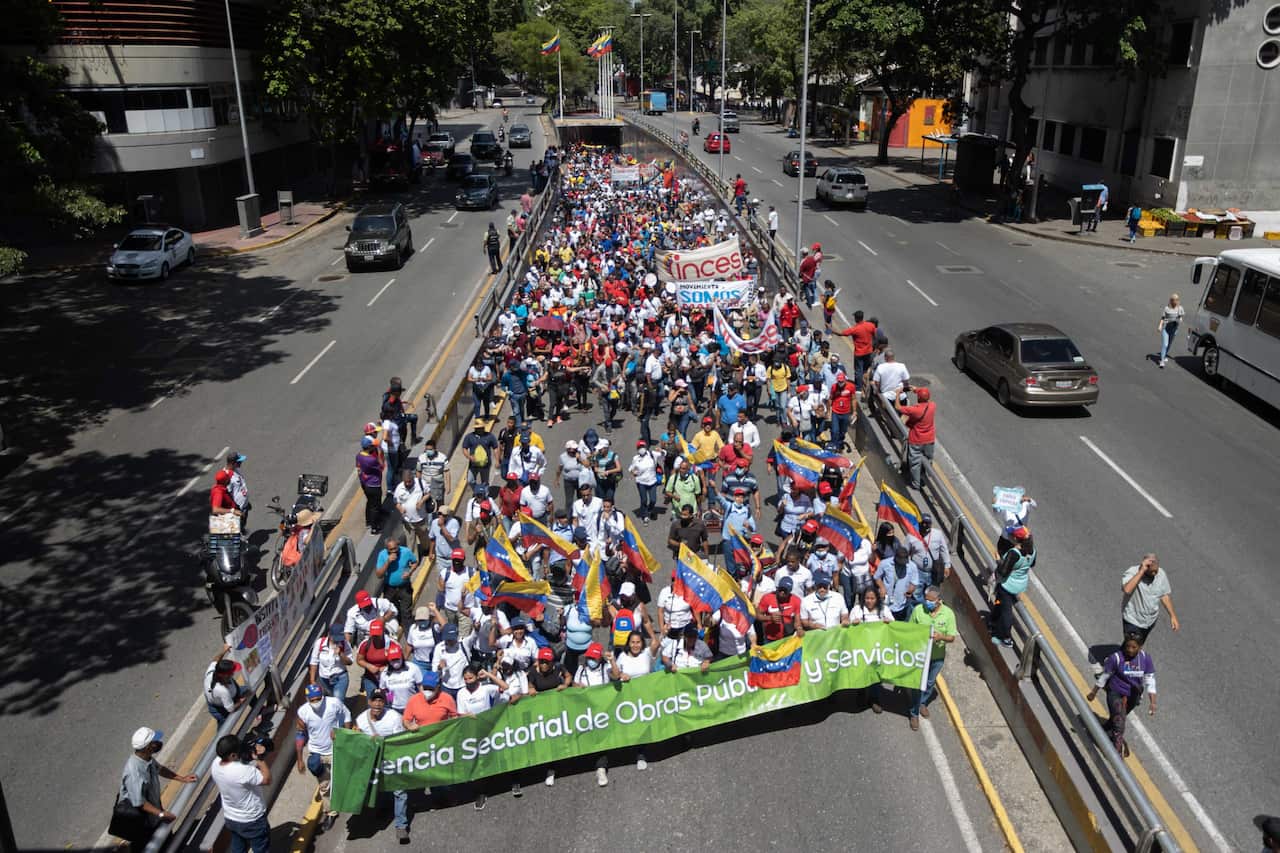 Workers of the public administration take part in a Chavista march for Workers Day, in Caracas, Venezuela, 01 May 2022.