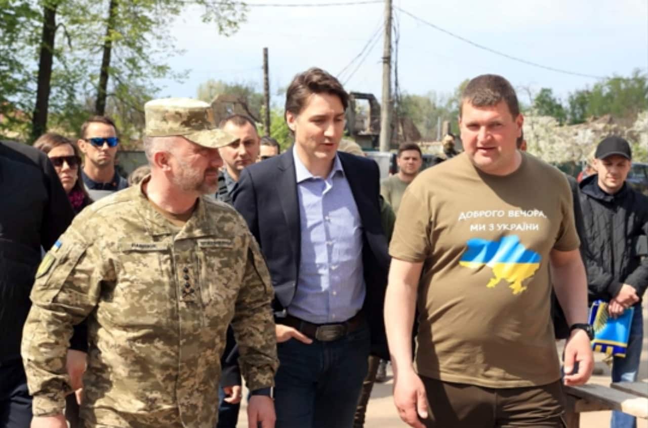 This image provided by the Irpin Mayor's Office shows Canadian Prime Minister Justin Trudeau walking with mayor Oleksandr Markushyn, right, in Irpin, Ukraine, Sunday, May 8, 2022. Trudeau made a surprise visit to Irpin on Sunday. 