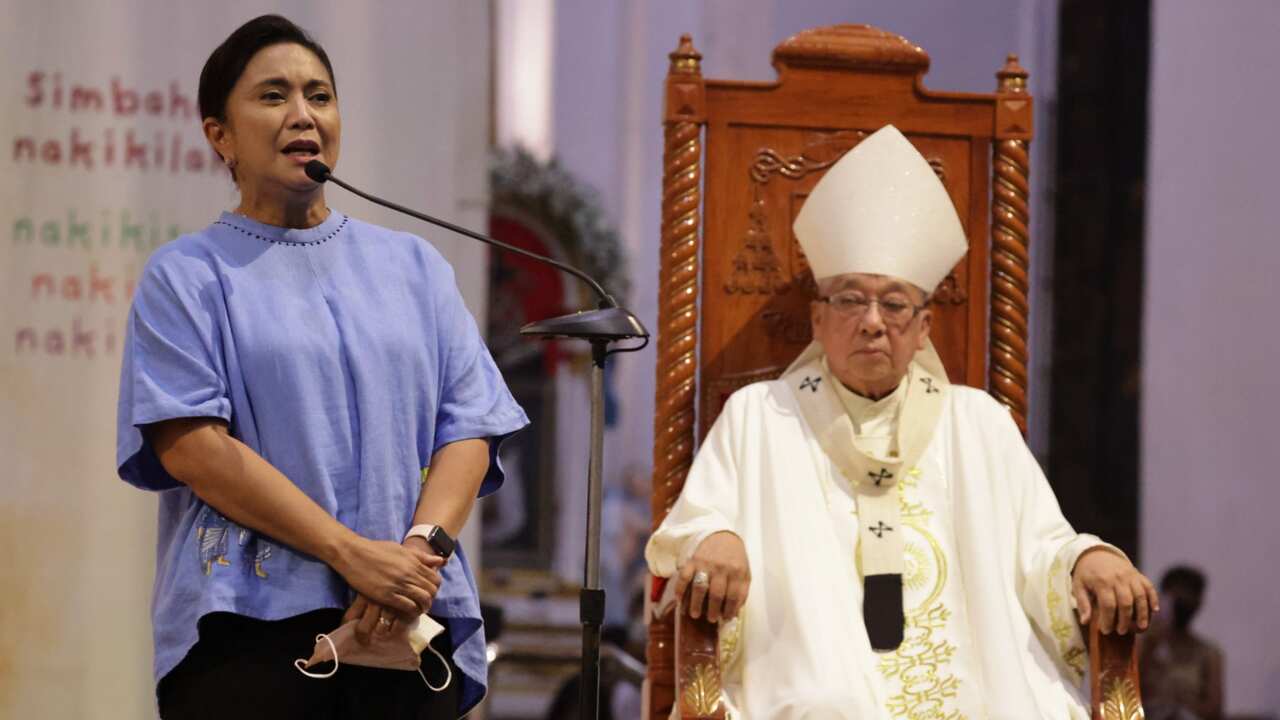 Vice President Leni Robredo, left, talks beside Archbishop Rolando Tirona as she hears mass in Naga City, Camarines Sur, eastern Philippines Tuesday, May 10, 2022