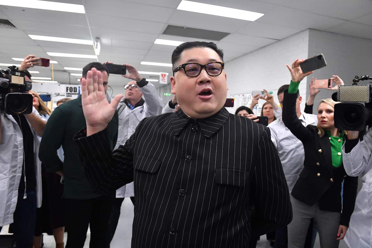 A man dressed as North Koreas leader Kim Jong-un arrives as Prime Minister Scott Morrison leaves Extel Technologies manufacturing facility on Day 33 of the 2022 federal election campaign, in Melbourne, in the seat of Chisholm. Friday, May 13, 2022. (AAP I