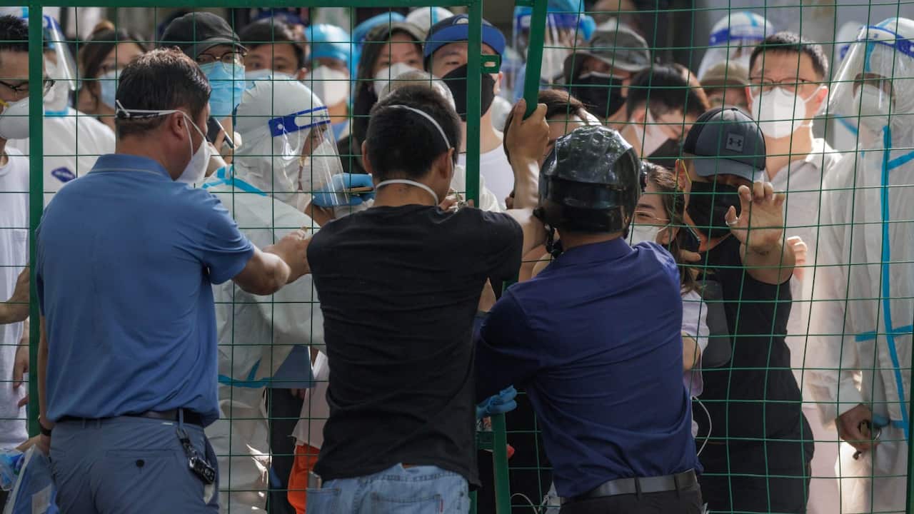 People argue with police behind quarantine fence during the protest, amid new round of COVID-19 lockdowns, in Shanghai, China, 06 June 2022