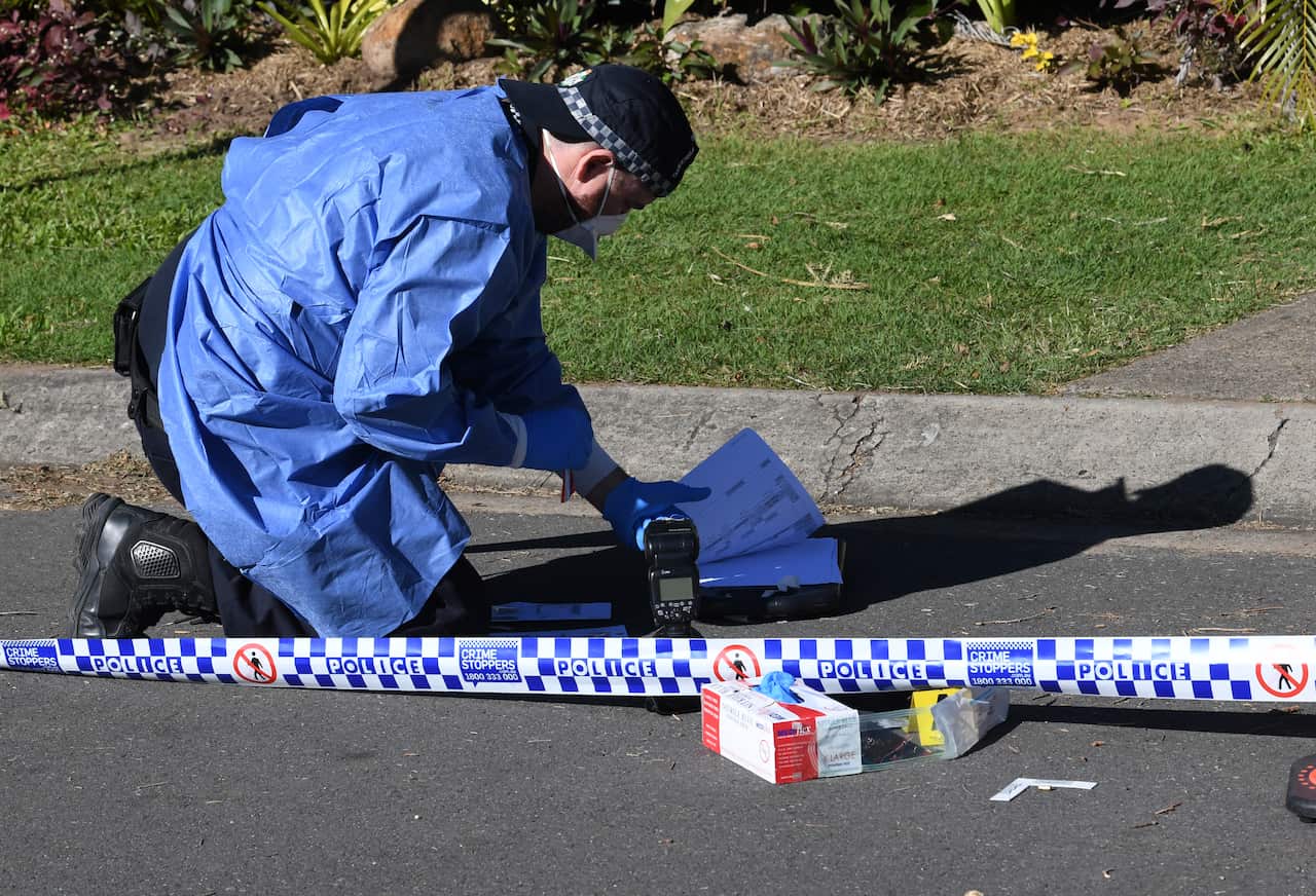 Police are seen gathering evidence outside the home of Australian boxer Justis Huni in Brisbane, Thursday, June 9, 2022. Queensland police are investigating a drive-by shooting at the home of Australian boxing champion Justis Huni's south Brisbane propert