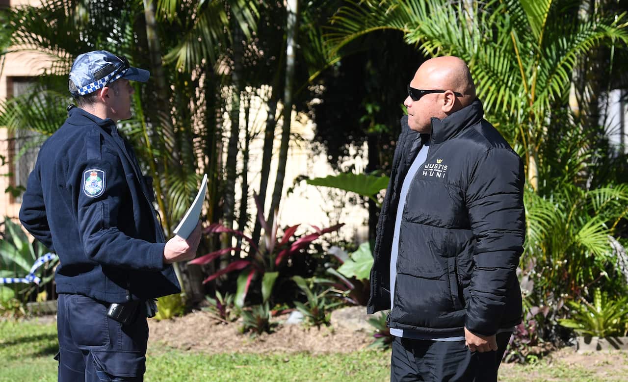 Rocki Huni, (right) trainer and father of boxer Justis Huni is seen talking to a Police officer outside his home in Brisbane, Thursday, June 9, 2022. Queensland police are investigating a drive-by shooting at the home of Australian boxing champion Justis 