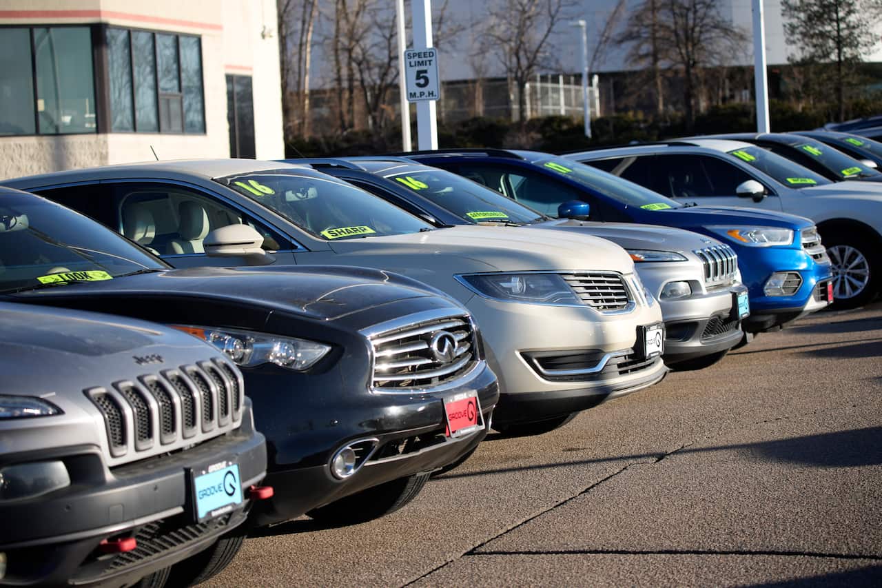 Used vehicles sit in a storage lot at a Toyota dealership Sunday, Feb. 27, 2022, in Englewood, Colo.  Record low-interest mortgages are long gone. Credit card rates will likely rise. You'll pay more for an auto loan. The unusually large three-quarter poin