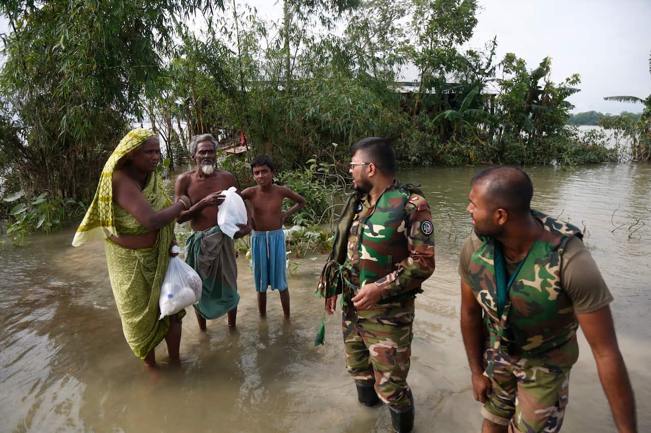 Bangladesh Army official distribute free food to flood victims after a widespread flood in Sylhet district, in Bangladesh, 23 June 2022. 
