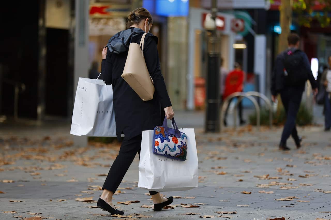 People walk in front of retail stores in Perth, Tuesday, June 21, 2022