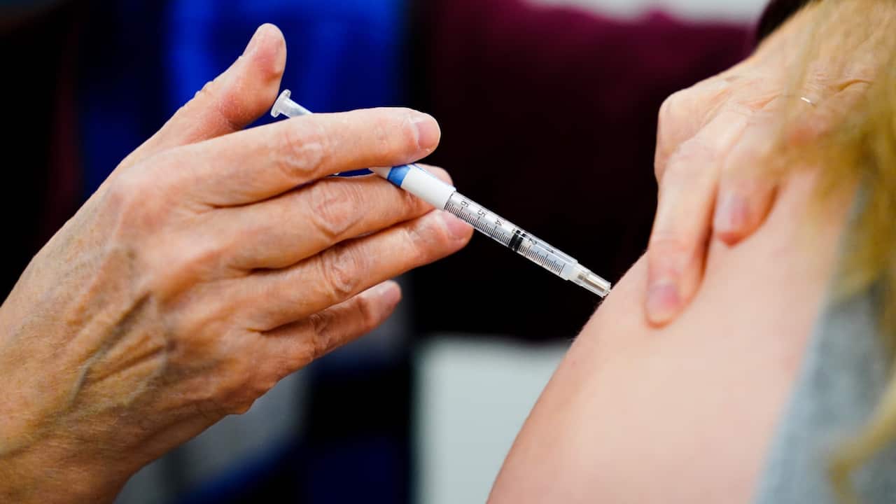 A health worker administers a dose of a COVID-19 vaccine during a vaccination clinic at the Keystone First Wellness Center in Chester, Pa., on Dec. 15, 2021.
